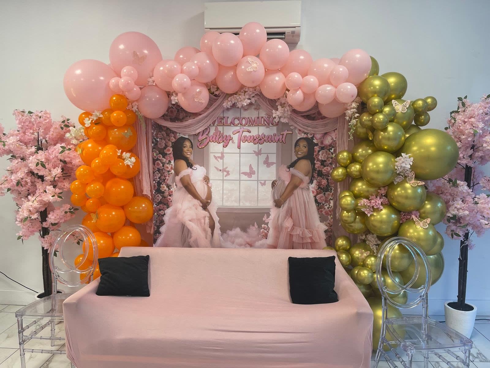 Pink, orange and gold engagement celebration backdrop at Elegance on Varet